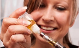 Girl Loading a Vaporizer pen